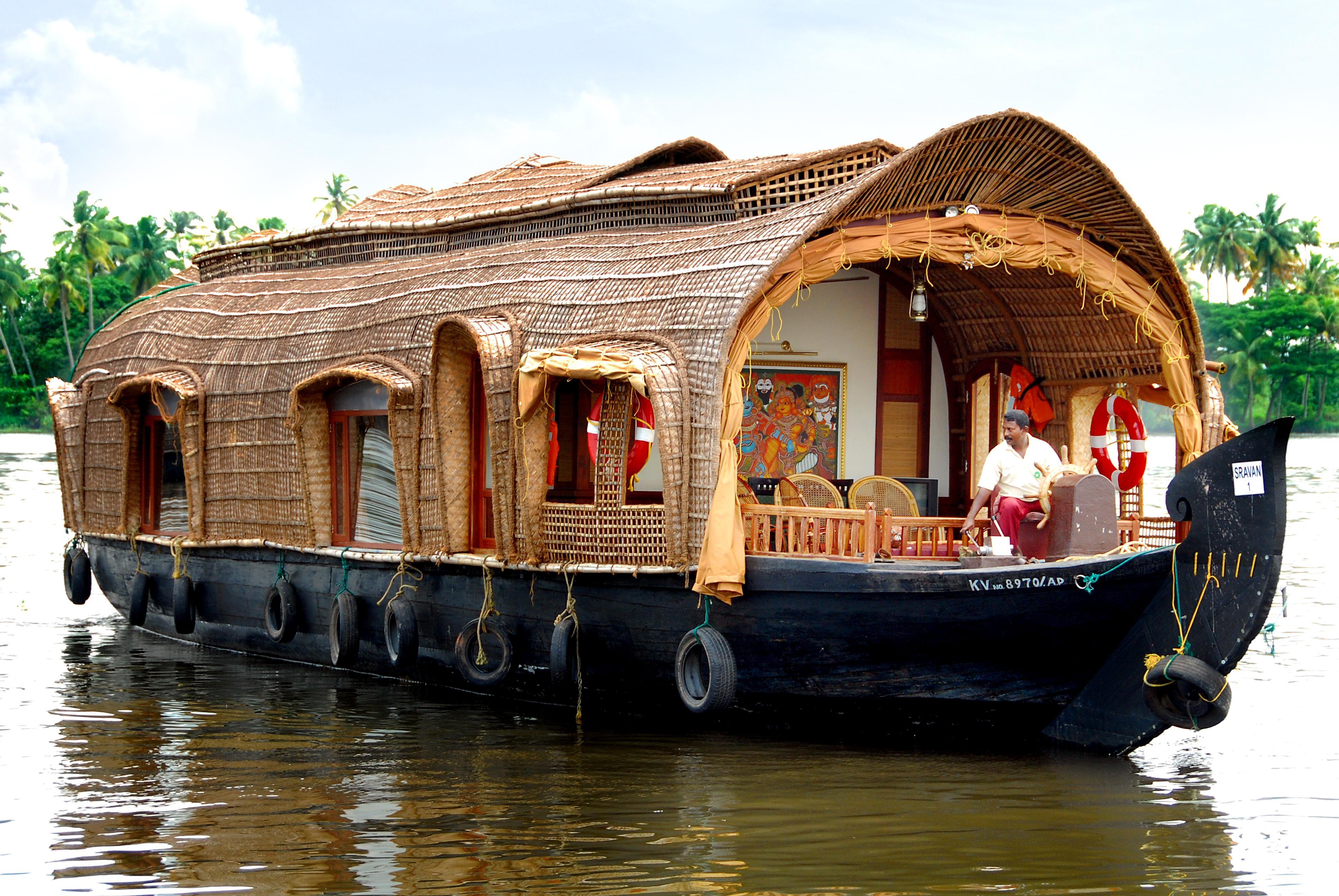 A luxury traditional Kerala houseboat cruising through the Alappuzha backwaters.